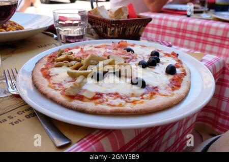 Une pizza classique quattro stagioni servie à l''extérieur dans un restaurant pizzeria de Lucques, en Italie Banque D'Images