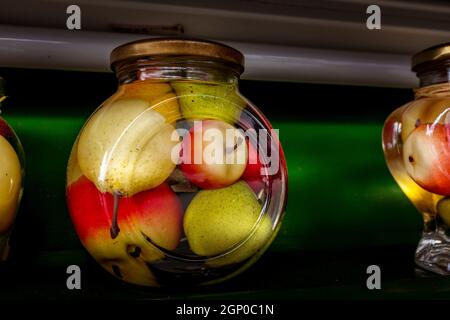 Conserves de pommes et de poires conservées dans un grand pot en verre sur la tablette Banque D'Images