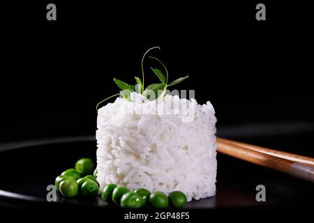 Une photo prise à la verticale d'un bol de riz blanc long grains cuits, tourné à partir de ci-dessus, sur un fond bleu sarcelle avec une place pour le texte Banque D'Images