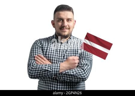 Homme blanc tenant un drapeau de la Lettonie souriant confiant avec des bras croisés isolés sur un fond blanc. Banque D'Images