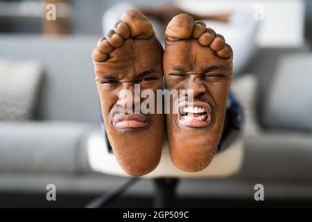 Pieds odeur et expression de douleur. Pied africain Sad Stinky Banque D'Images