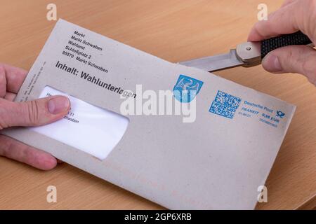 L'homme ouvre une enveloppe avec des documents de vote postal pour l'élection des membres du Bundestag allemand sur 26.09.2021, Allemagne Banque D'Images