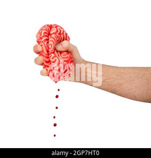 Serre la main d'un cerveau en caoutchouc, métaphore du concept squeeze le cerveau. Banque D'Images