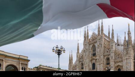 Le drapeau italien qui flotte au-dessus de la cathédrale Duomo de Milan. Voyages et tourisme en Italie. Célèbre lieu touristique Banque D'Images