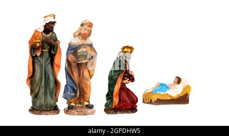 Trois Sages rois et bébé Jésus Figurines en céramique isolées dessus un arrière-plan blanc Banque D'Images