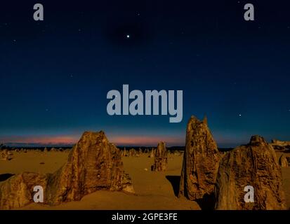 Vue nocturne du désert des Pinnacles illuminé par un clair de lune avec un coucher de soleil après la lueur, parc national de Nambung, Cervantes, Australie occidentale, Australie Banque D'Images