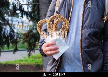 Churros, petit déjeuner typiquement espagnol. Burros traditionnel mexicain avec noix dans la main mâle. Croustillant et savoureux. Banque D'Images