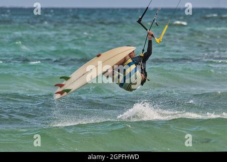 Kite surfeur faisant de grands sauts risqués dans l'océan Banque D'Images