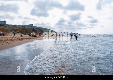 Sariyer, Istanbul, Turquie - 07.14.2021: Quelques Turcs nageant debout en se promenant en s'amusant assis sur la plage de Kilyos dans la chaude journée ensoleillée d'été pour e Banque D'Images