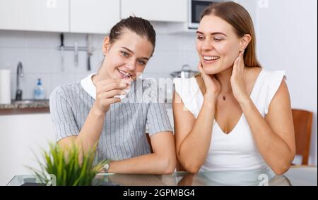 De jeunes filles heureuses qui ont l'air de faire des rencontres et de discuter à table Banque D'Images