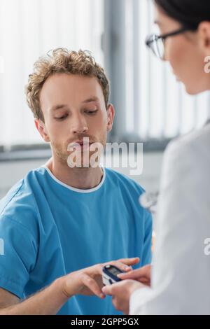 trouble médecin plaçant l'oxymètre de pouls sur le doigt sur le patient à l'hôpital Banque D'Images