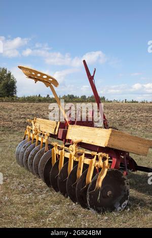 Ancienne herse à disques ou découpe, un ancien équipement agricole utilisé pour labourer le sol, dans les Prairies canadiennes Banque D'Images