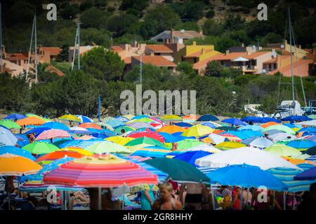 Colored sun umbrella on the beach during holidays Stock Photo