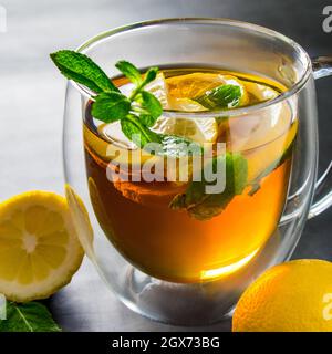 Thé avec citron et menthe dans une tasse transparente. Médecine alternative pour le traitement. Banque D'Images