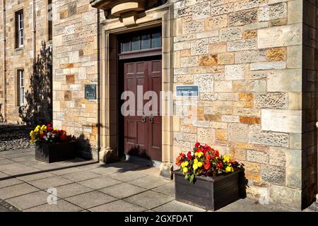 ST ANDREWS UNIVERSITY FIFE SCOTLAND COLLEGE PORTE DANS NORTH STREET ET DES BAIGNOIRES DE FLEURS AVEC DES BEGONIAS COLORÉES Banque D'Images