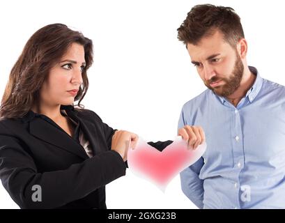 Une femme en colère déchirant un cœur en papier rouge Banque D'Images
