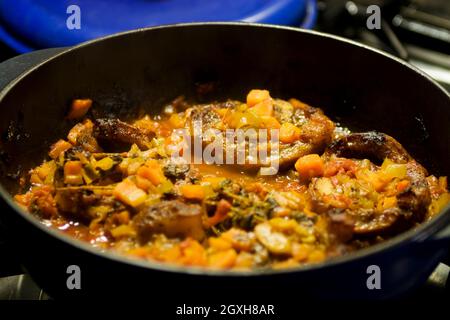 Veal shanks braised in vegetable in pan Stock Photo