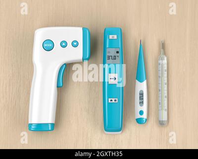 Différents types de thermomètres médicaux sur table en bois, vue de dessus Banque D'Images