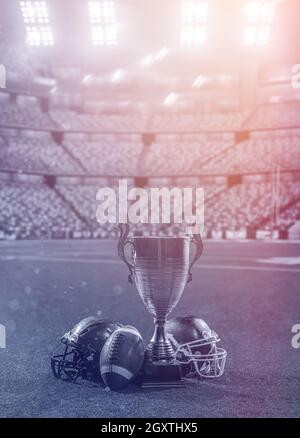 Libre shot du football américain,casques et trophy sur pelouse au stade moderne avec des fusées éclairantes et des lumières dans la nuit Banque D'Images