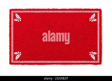 Tapis de bienvenue blanc rouge des fêtes avec coins en Holly isolés sur fond blanc. Banque D'Images