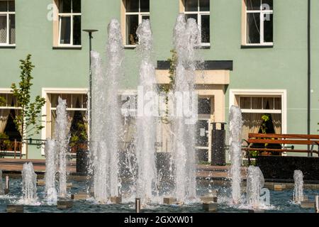 Fontaine et jets d'eau lors d'une journée ensoleillée sur une place de la ville Banque D'Images