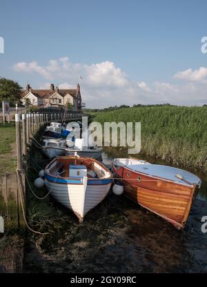 Bateaux sur la petite rivière Glaven à marée basse à CLEY à côté de la mer et les lits de roseaux de CLEY Marshes Norfolk Heritage Coast Angleterre Royaume-Uni Banque D'Images