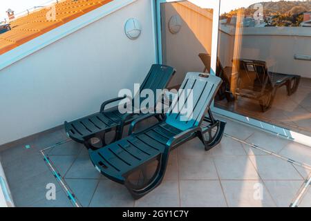 Des chaises longues vides sur un balcon par temps ensoleillé à Rovinj, en Croatie Banque D'Images