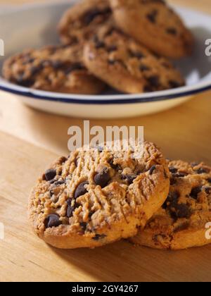 biscuits aux pépites de chocolat sur une table en bois biscuits aux pépites de chocolat sur une assiette en étain sur une table en bois Banque D'Images