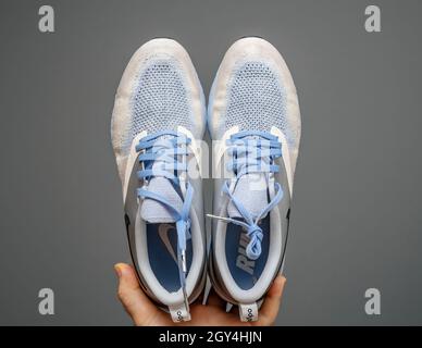 POV main tenue masculine montrant de nouvelles chaussures de running de luxe Nike Zoom React Banque D'Images