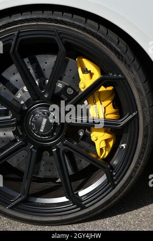 Circuit de Mugello, Italie - 23 septembre 2021 : détail d'une jante en alliage avec étrier de frein jaune d'une Porsche 911 dans le paddock du circuit de Mugello. Banque D'Images