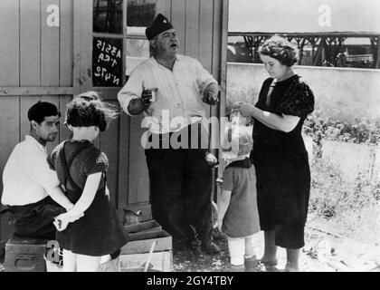 Une fois évacués par le gouvernement français, les alsaciens et les résidents de Lorraine sont maintenant ramenés dans la région occupée par les Allemands.Les réfugiés qui arrivent à Saint-Dizier sont alimentés par la NSV.Sur la photo : une femme avec deux petits enfants discute avec un homme âgé devant une cabane en bois.[traduction automatique] Banque D'Images