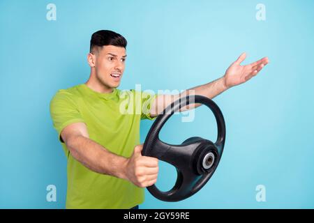 Photo portrait homme en t-shirt vert voiture de conduite arguant isolé pastel bleu couleur fond Banque D'Images