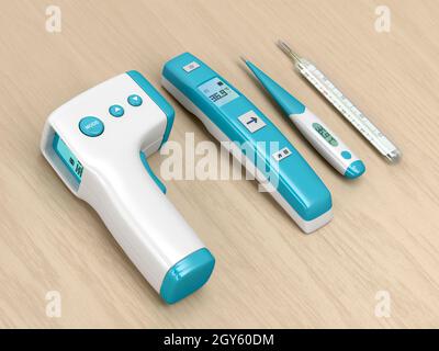 Quatre types différents de thermomètres médicaux sur table en bois Banque D'Images