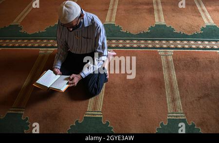 Mumbai, Inde.07e octobre 2021.Un dévot portant un masque comme précaution contre la propagation du covid-19 vu lire un livre Saint à l'intérieur d'une mosquée pendant la réouverture des lieux religieux.La Brihanmumbai Municipal Corporation (BMC) a permis à tous les lieux religieux de rouvrir pour que les dévotés prient après le verrouillage dû au virus corona.(Photo par Ashish Vaishnav/SOPA Images/Sipa USA) crédit: SIPA USA/Alay Live News Banque D'Images