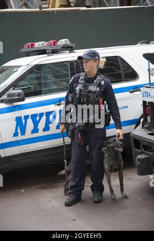 NYPD Emergency Service Canine Patrouille officier avec chien dans la rue à Midtown Manhattan pendant la réunion de l'Assemblée générale des Nations Unies traitant de la crise climatique, Covid et d'autres questions.LE président AMÉRICAIN Biden prononce également son premier discours en personne à l'ONU. Banque D'Images