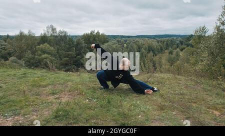 L'homme caucasien est engagé dans la gymnastique traditionnelle chinoise qigong et tai chi Banque D'Images