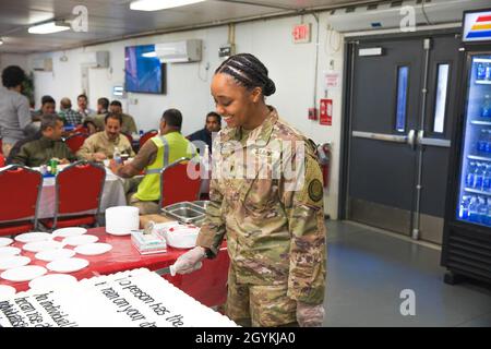 Armée des États-Unis le 1er lieutenant Bethany Deneal, officier exécutif de la Force opérationnelle interarmées combinée–opération inhérente Resolve Signals Intelligence Sustainability Company, se porte volontaire pour couper un gâteau à Union III à Bagdad, en Irak, le 20 janvier 2020.Le CJTF-OIR a souligné ce moment pour se souvenir du service du Dr. Martin Luther King Jr. (États-UnisPhoto de l'armée par la SPC.Khalil Jenkins) Banque D'Images