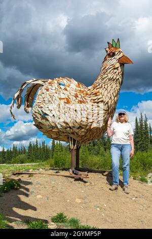 États-Unis, Alaska, poulet, sculpture métallique, visiteur féminin Banque D'Images