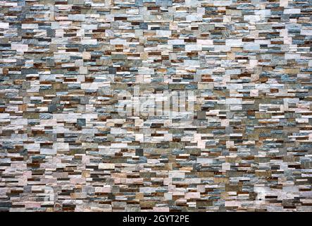 Mur rustique en mosaïque en pierre faisant face aux carreaux de céramique en porcelaine en grès Banque D'Images