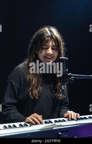Fille gaie dans le processus d'enregistrement de contenu musical dans le studio, l'enregistrement de la voix dans un microphone professionnel, le concept d'apprentissage du piano Banque D'Images