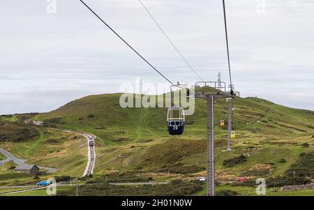 Des téléphériques sur la Grande Orme tandis que les célèbres tramways se préparent à passer les uns les autres sur la côte nord du pays de Galles en octobre 2021. Banque D'Images