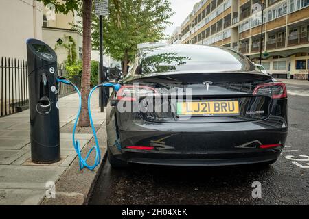Londres - octobre 2021 : voiture électrique Tesla en charge à la station de charge dans la rue dans le sud-ouest de Londres Banque D'Images