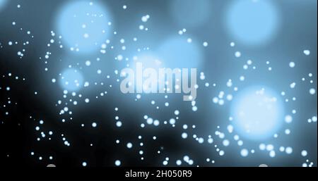 Image de plusieurs spots lumineux se déplaçant dans un mouvement hypnotique sur fond bleu Banque D'Images