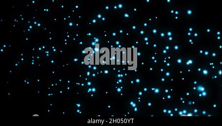 Image de plusieurs taches bleues brillantes de lumière se déplaçant dans un mouvement hypnotique sur fond noir Banque D'Images