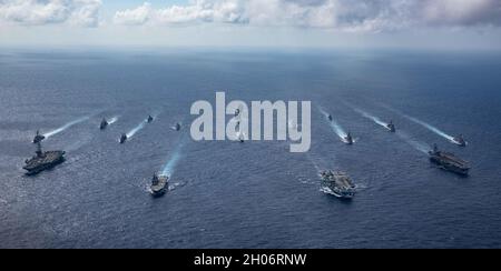 Mer des Philippines, États-Unis.03 octobre 2021.Formation de groupes de grève multinationaux voguant en formation pendant les exercices du 3 octobre 2021, dans la mer des Philippines.Transporteurs de gauche à droite : le porte-avions USS Carl Vinson de la Marine américaine de Nimitz, le destroyer japonais de la classe Hyuga JS ISE, le porte-avions HMS Queen Elizabeth de la Marine britannique et le porte-avions de la classe Nimitz de la Marine américaine Ronald Reagan.Crédit : MC2 Jason Tarleton/États-UnisNavy/Alamy Live News Banque D'Images