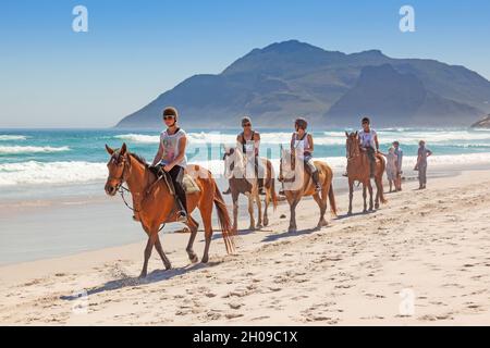 Un groupe de cavaliers non identifiés sur long Beach, dans la péninsule du Cap, en Afrique du Sud. Banque D'Images