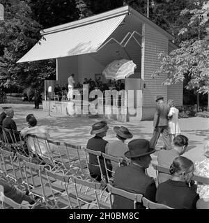 Kurgäste sitzen auf Ihren Plätzen und das hören dans Kurkonzert Wildbad im Schwarzwald, Deutschland 1930er Jahre. Les curistes ont pris leur place et à écouter la musique de l'orchestre à Wildbad Spa en Forêt-Noire, Allemagne 1930. Banque D'Images