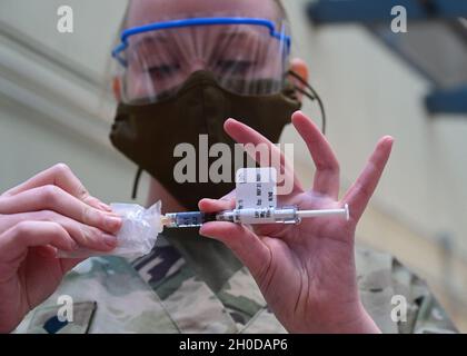 SPC.Alexis Ruth, un spécialiste des soins de santé affecté au détachement médical de la Garde nationale de l'armée du Maryland, se prépare à administrer un vaccin, le 30 janvier 2021, au centre médical des anciens combattants à Baltimore, Maryland.Ruth faisait partie d'une équipe mobile de soutien à la vaccination de la Garde nationale du Maryland qui a travaillé avec le ministère des anciens Combattants et d'autres organismes de santé pour distribuer des centaines de vaccins aux anciens combattants. Banque D'Images