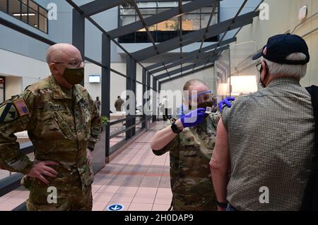 SPC.Alexis Ruth, un spécialiste des soins de santé affecté au détachement médical de la Garde nationale de l'armée du Maryland, administre un vaccin alors qu'il est observé par le colonel de l'armée américaine Eric Allely, chirurgien de la Garde nationale du Maryland, le 30 janvier 2021, au centre médical des anciens combattants à Baltimore, Maryland.Les membres de la Garde nationale du Maryland, de la Force de défense du Maryland, du ministère des anciens combattants et d'autres organismes de santé ont travaillé ensemble pour distribuer des centaines de vaccins aux anciens combattants. Banque D'Images