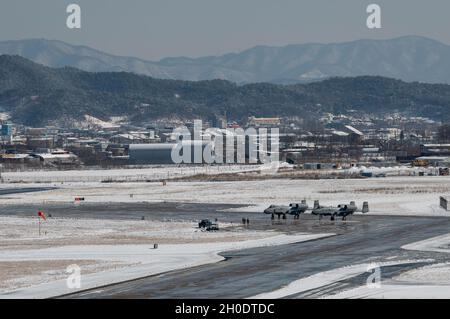 Deux Thunderbolt II A-10 sont installés sur une rampe à la base aérienne d'Osan, en Corée du Sud, le 4 février 2021.L'avion a été préparé pour un entraînement commun de routine au-dessus de l'aérodrome avec des hélicoptères Apache AH-64 affectés au bataillon de reconnaissance d'attaque de 4-2, 2e Brigade d'aviation de combat du Camp Humphreys, Corée du Sud. Banque D'Images